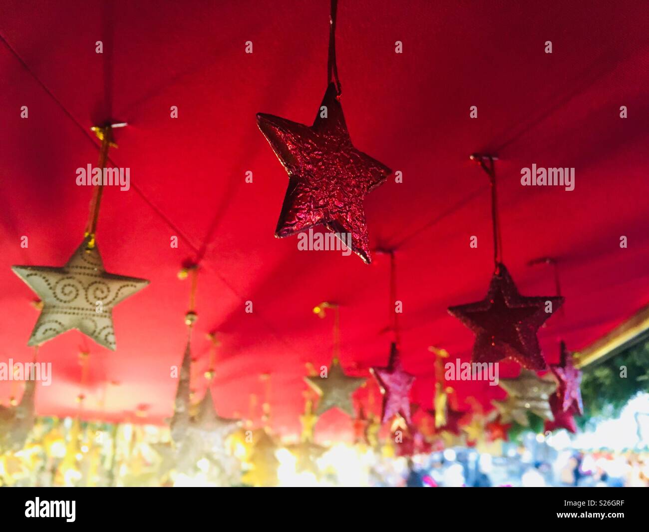 Star Decorations Hanging From The Ceiling Of A Market Stall