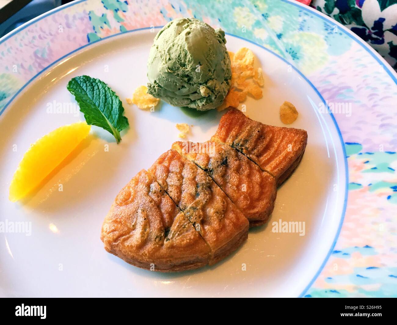 Taiyaki , Green tea ice cream and mango served for dessert at a luxury Japanese restaurant, New York City, USA - Smartphone Captured Stock Image