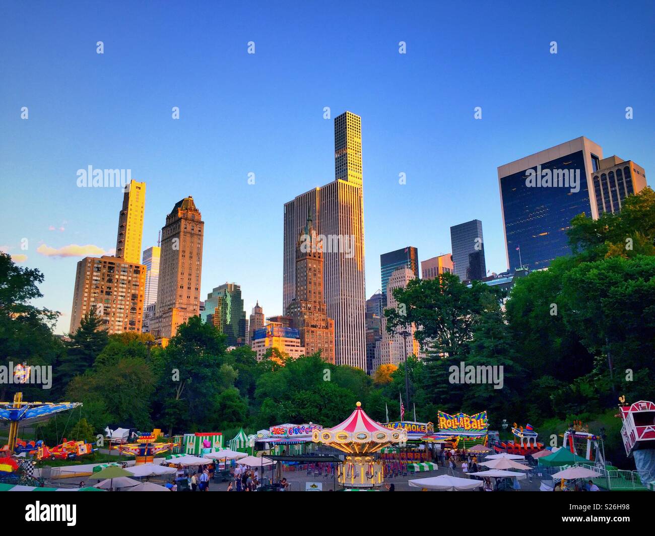 Victorian gardens carnival is an amusement park in the southern part of central park during the summer, NYC, USA - Smartphone Captured Stock Image