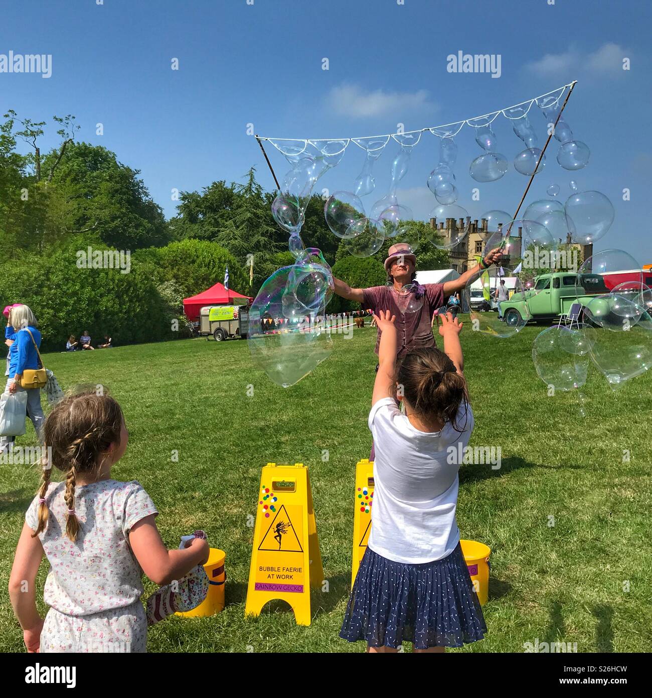 Entertaining children with giant soap bubbles at Sherborne Castle Country Fair, Sherborne, Dorset, England - Smartphone Captured Stock Image