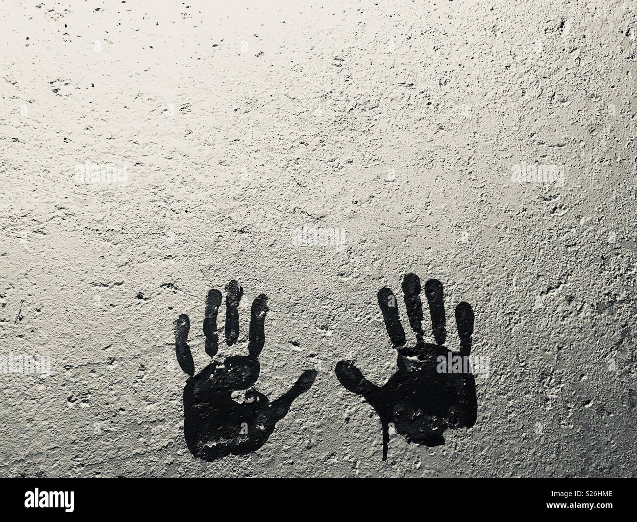 painted handprints on cement wall Stock Photo
