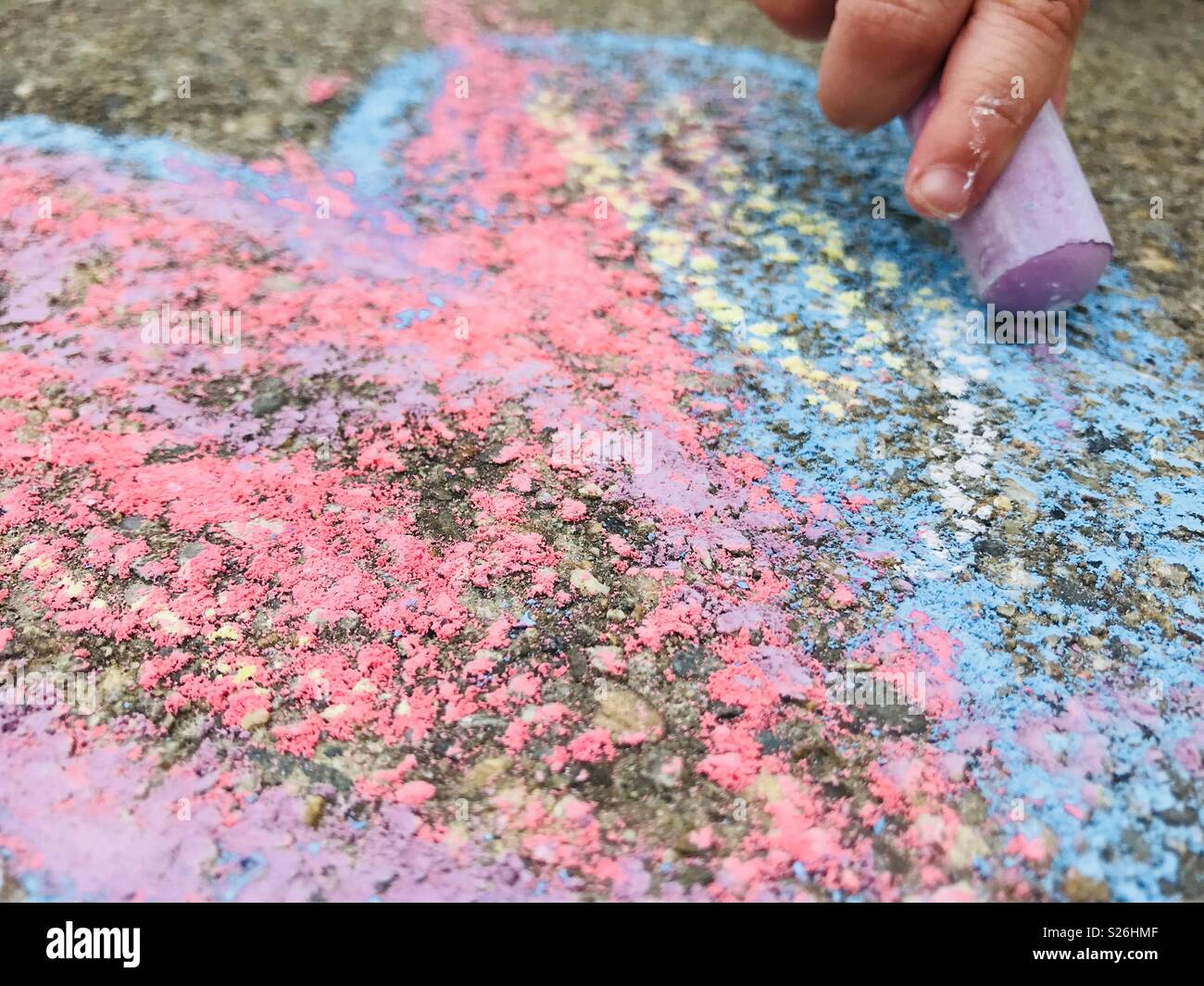 Kid coloring with chalk Stock Photo