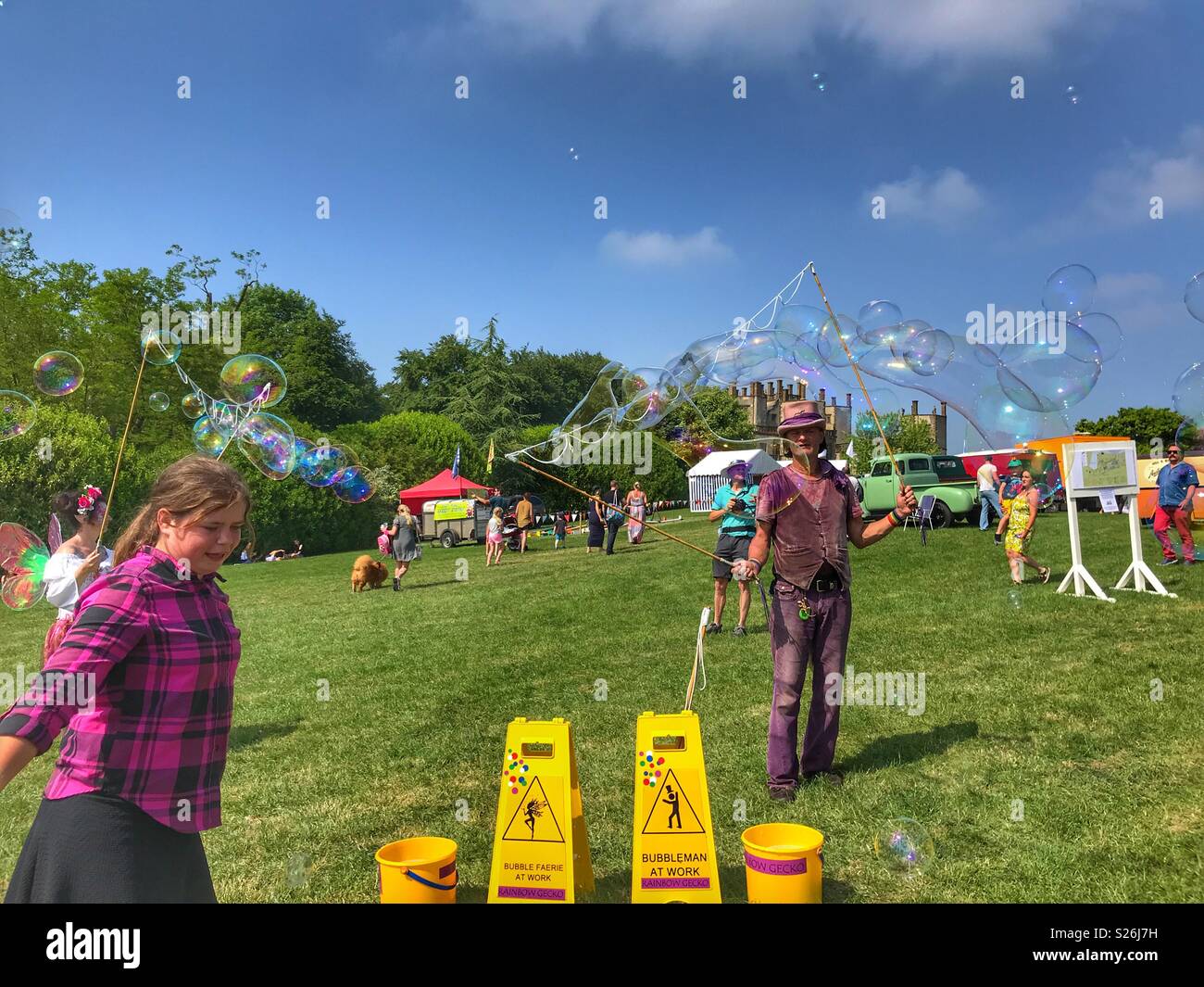 Bubbleman & Bubble Faerie at work creating soap bubbles, entertaining visitors at the Sherborne Castle Country Fair, Sherborne, Dorset, England - Smartphone Captured Stock Image