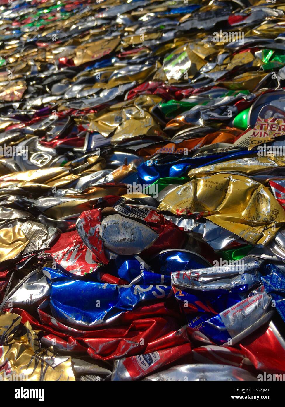 Crushed and compressed aluminium cans in a recycling plant Stock Photo