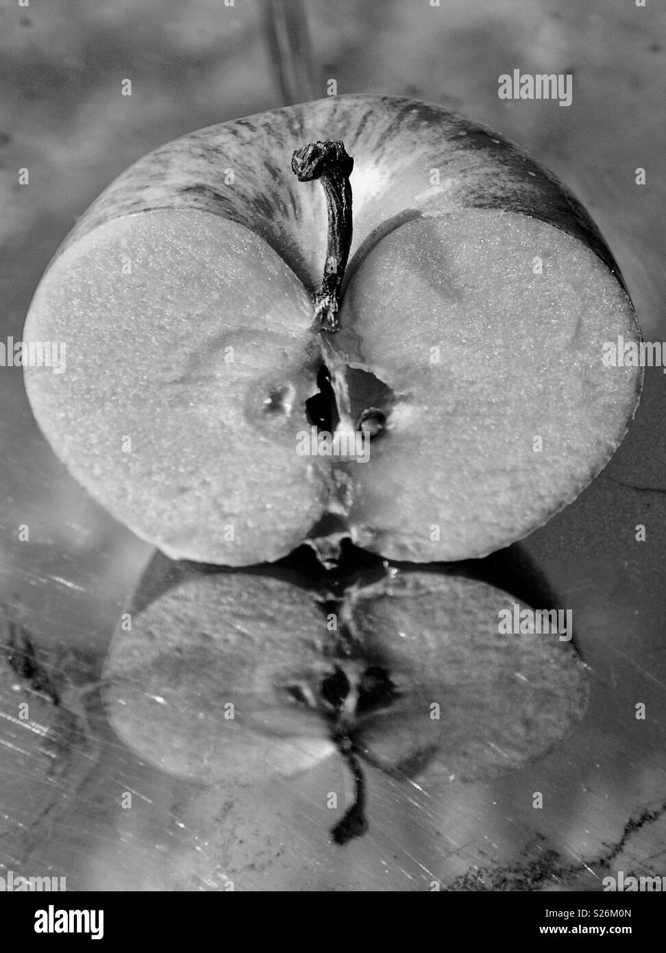 Still Life - Half an apple reflecting in stainless steel Stock Photo