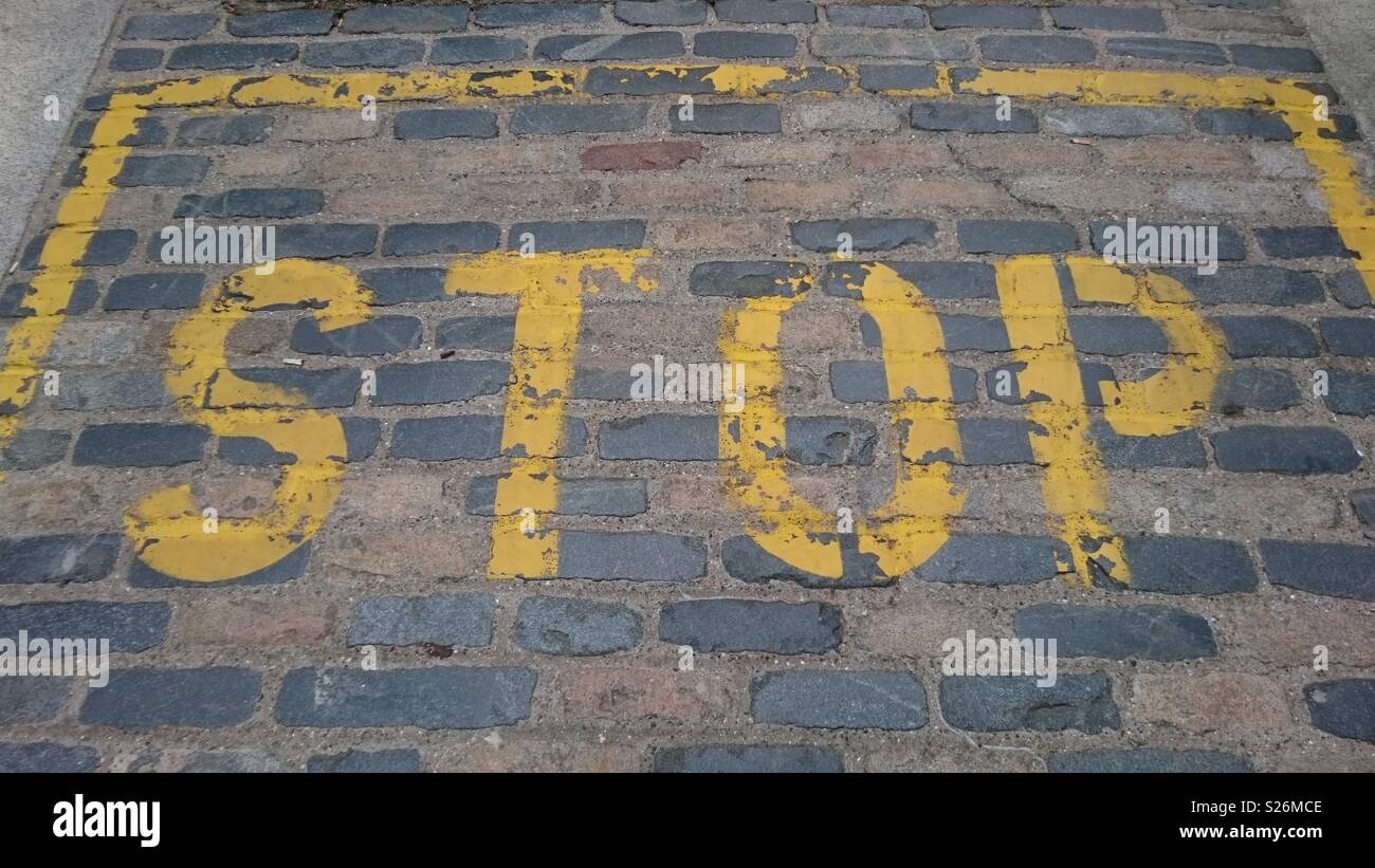 Stop painted in yellow in car park near Borough Market, London, in Spring. Stock Photo
