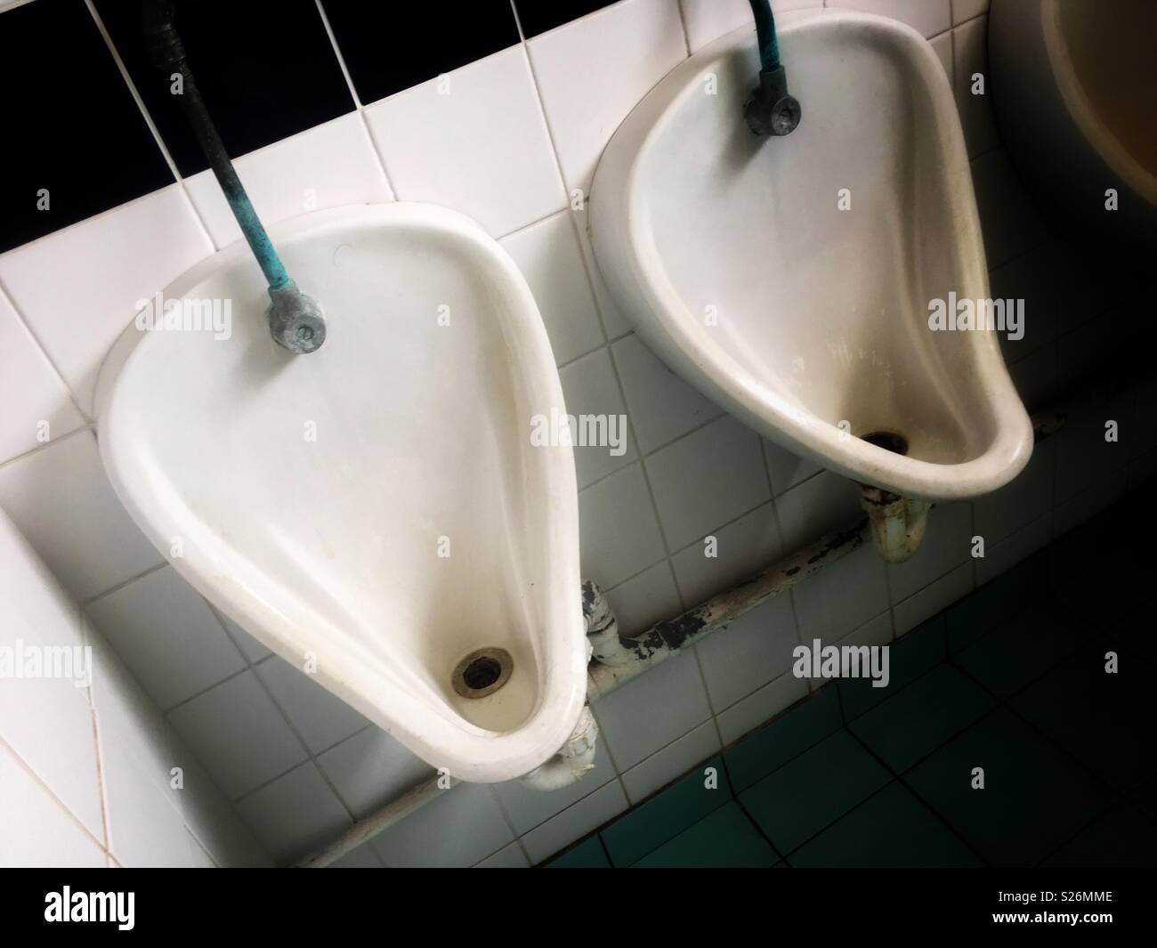 Men’s toilet urinal in pub UK Stock Photo