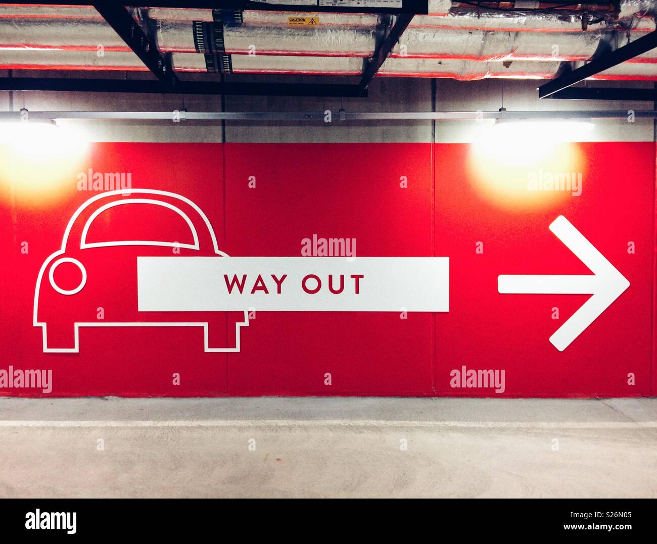 Sign in a car park showing the way out Stock Photo