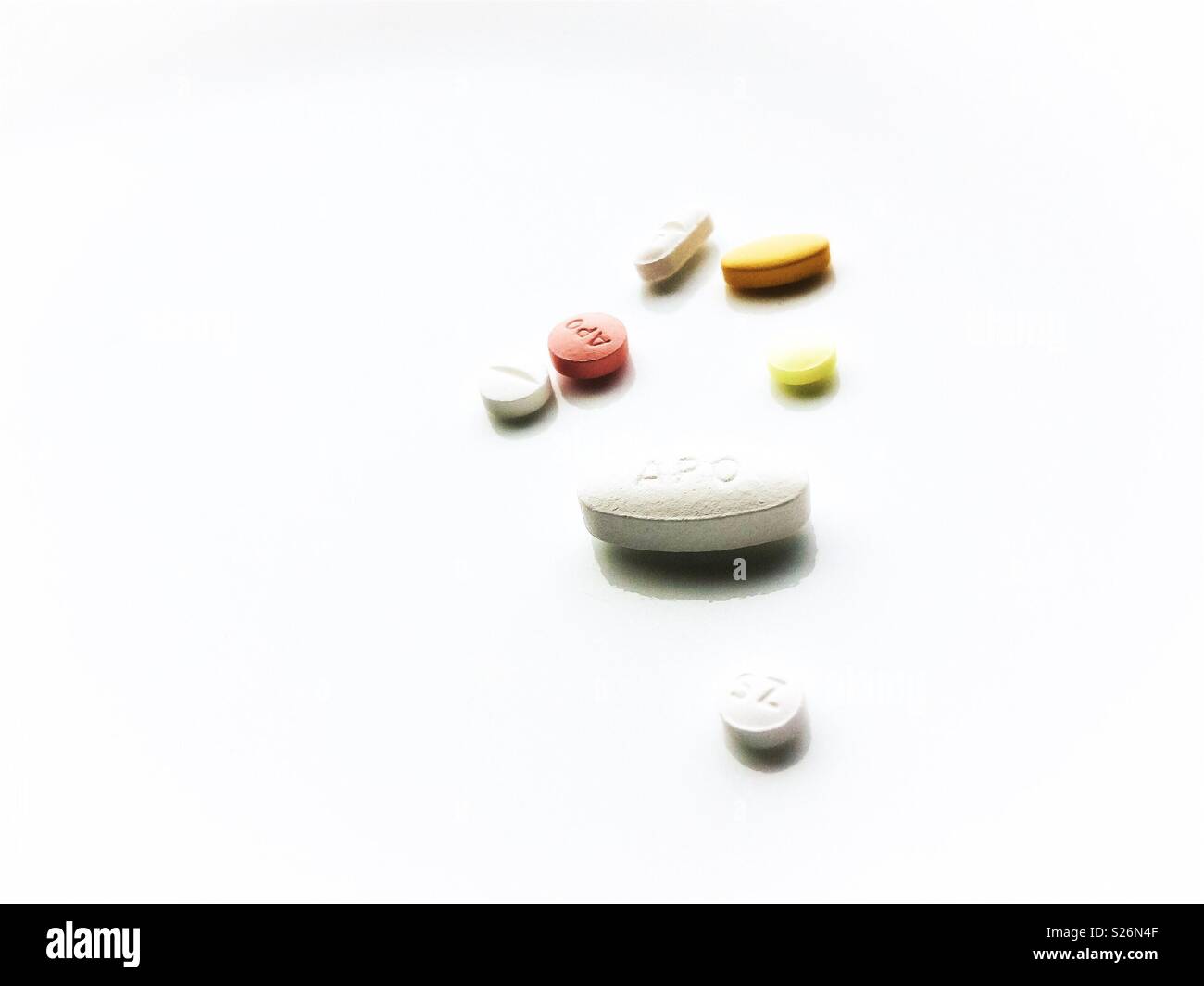 Pills isolated on white background. Medication treatment for heart condition. - Smartphone Captured Stock Image