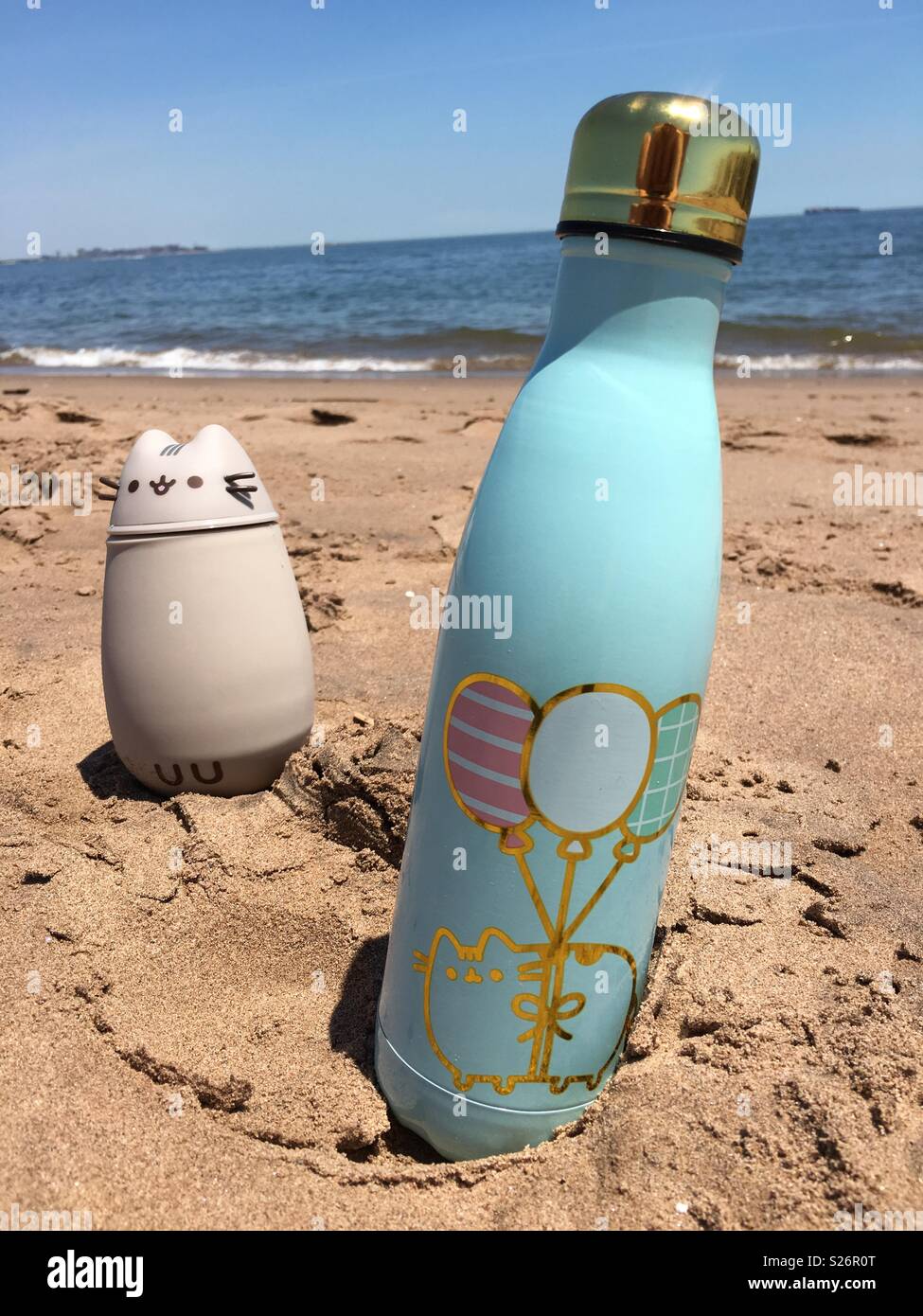 Two thermos on a beach in a sand Stock Photo - Alamy