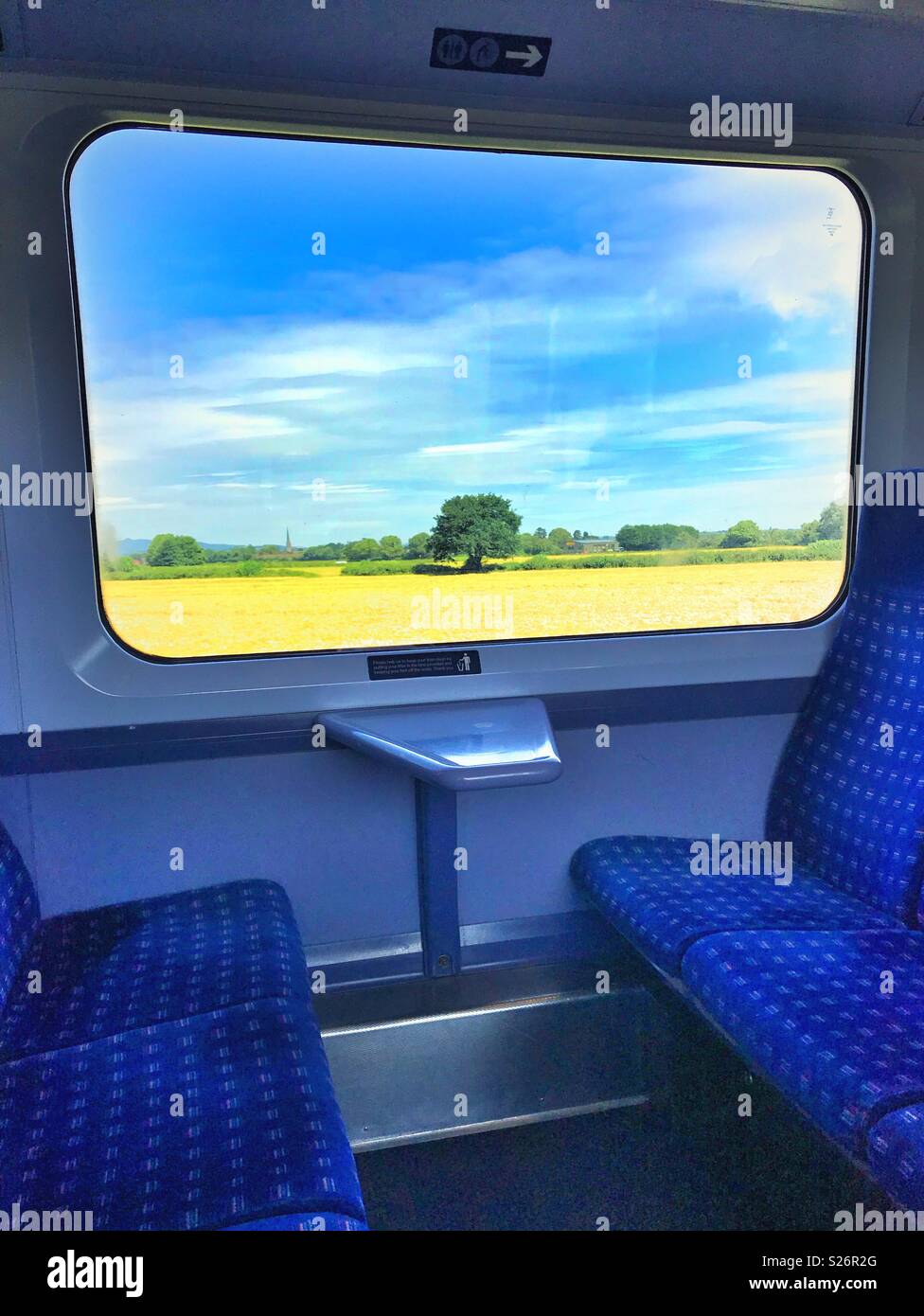 Looking through the window of an empty train at the passing landscape Stock Photo