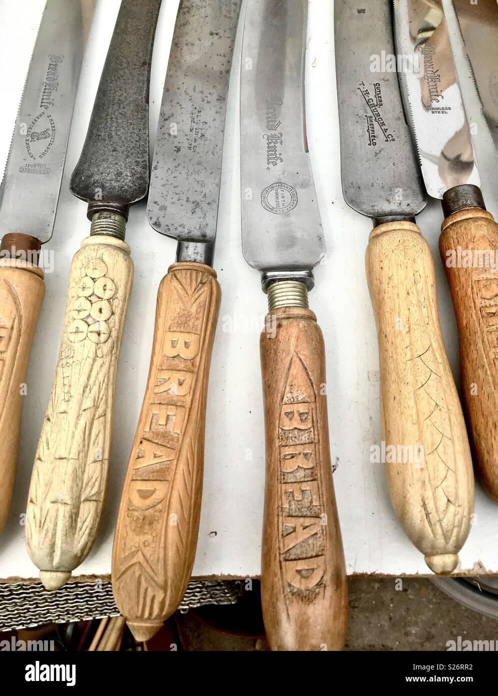 Antique bread knives on white table Stock Photo - Alamy