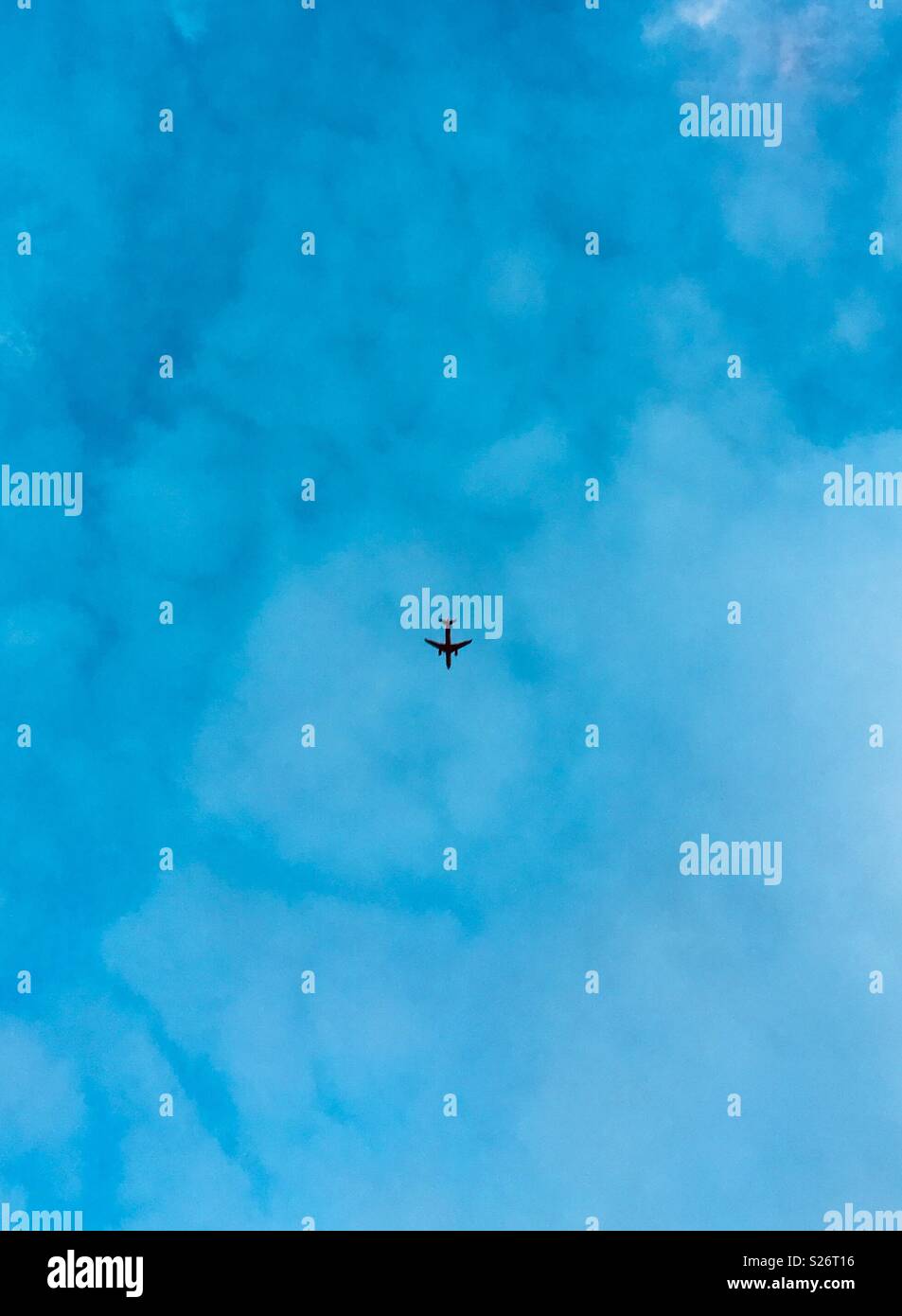 Airplane silhouette in blue sky - Smartphone Captured Stock Image