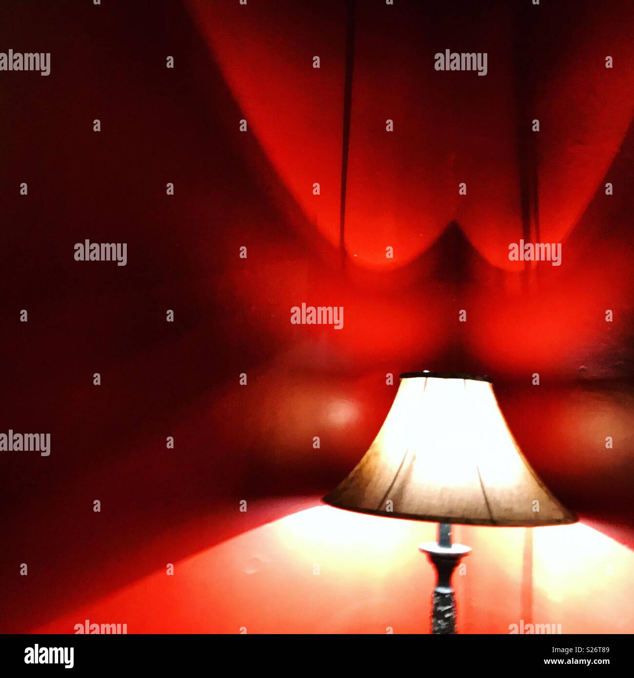 A lamp decorates a red room in Hotel California, Todos Santos, Baja California, Mexico. Some people think the music band Eagles composed their album Hotel California in this Mexican hotel. - Smartphone Captured Stock Image