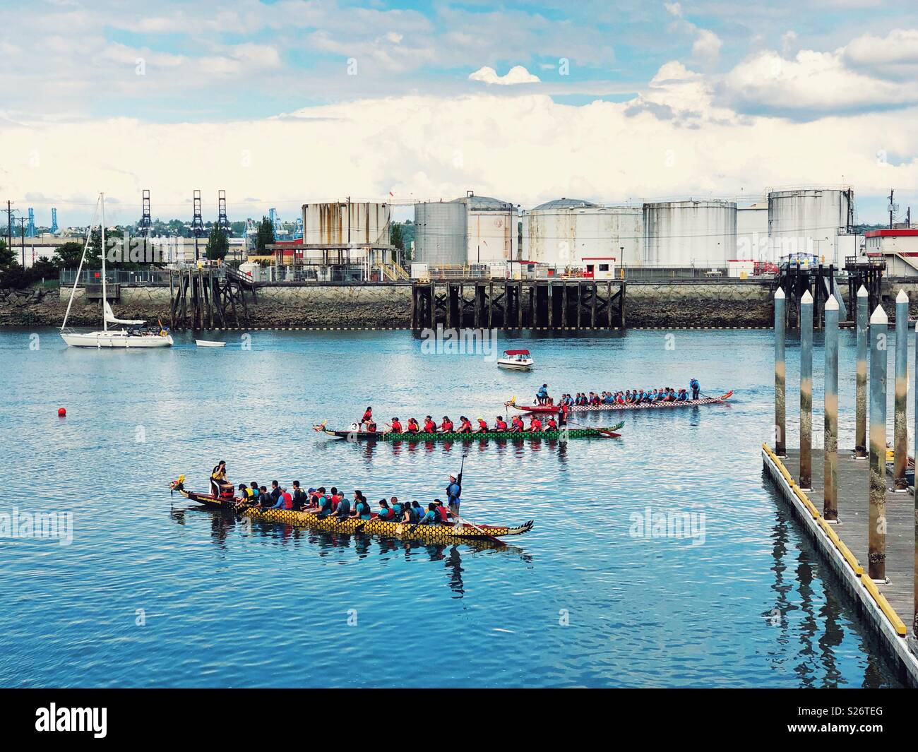 Colorful dragon boats race in Thea Foss waterway of WA, next to