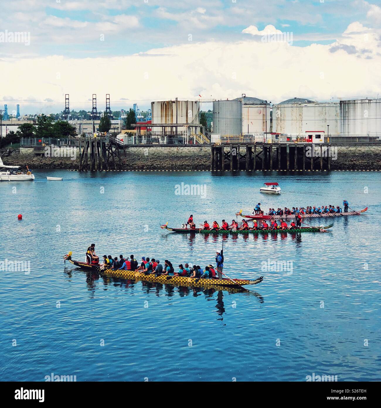 Colorful dragon boats race in Thea Foss waterway of WA, next to