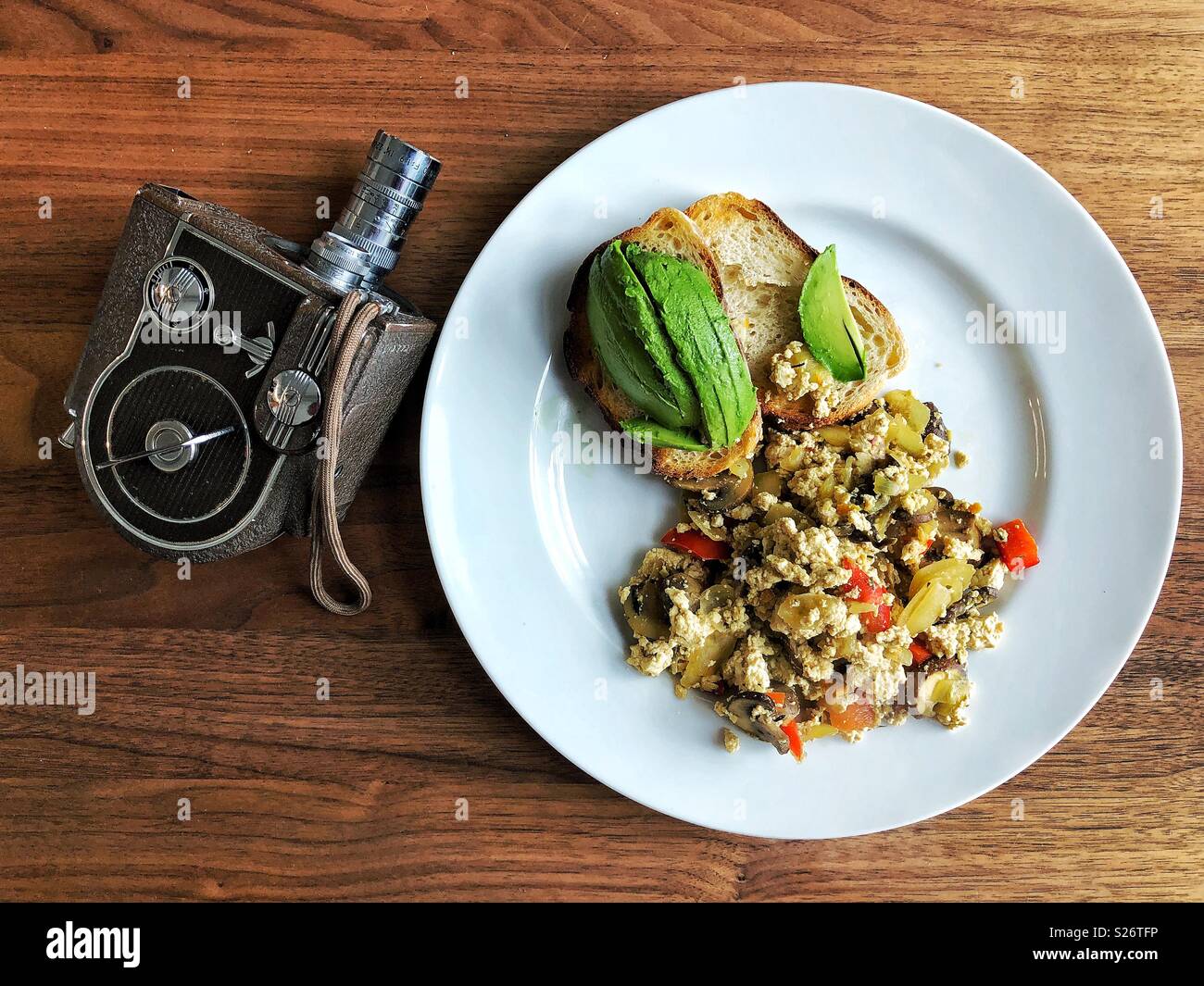 Healthy vegan lunch and vintage movie camera - Smartphone Captured Stock Image