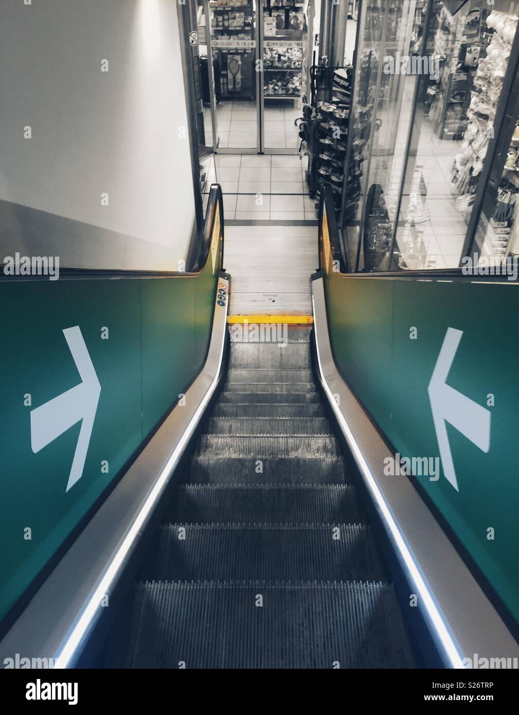 Down escalator in a shop with arrows - Smartphone Captured Stock Image