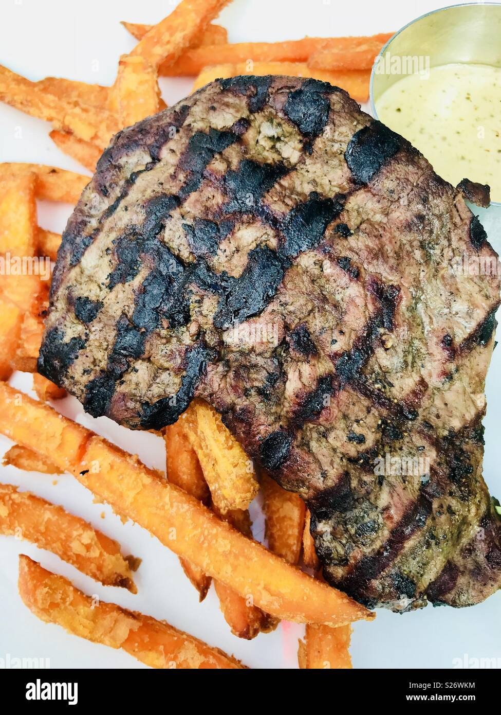 Steak with sweet potato fries and peppercorn sauce Stock Photo - Alamy