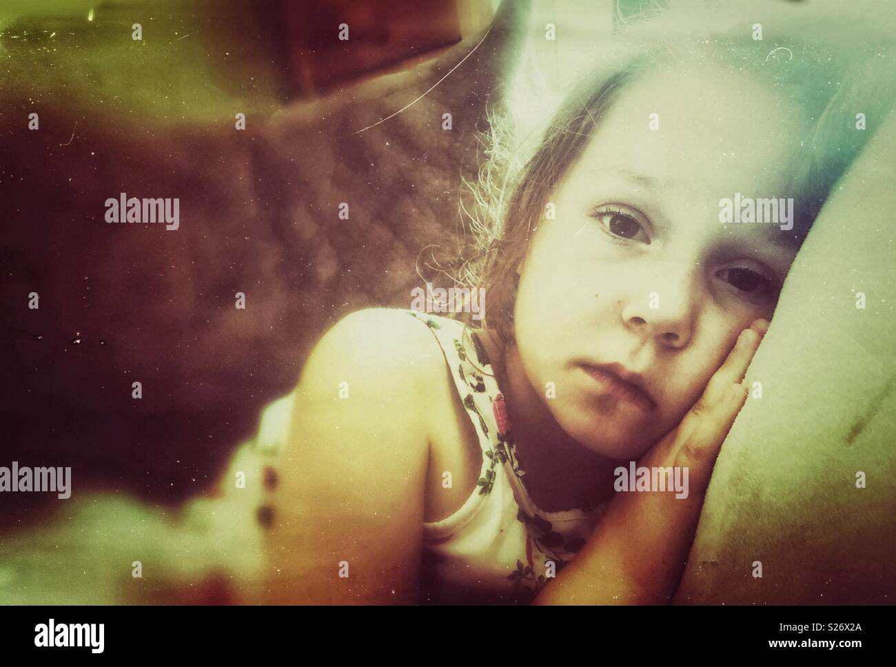 Creative portrait of sad 5 year old girl looking at camera - Smartphone Captured Stock Image