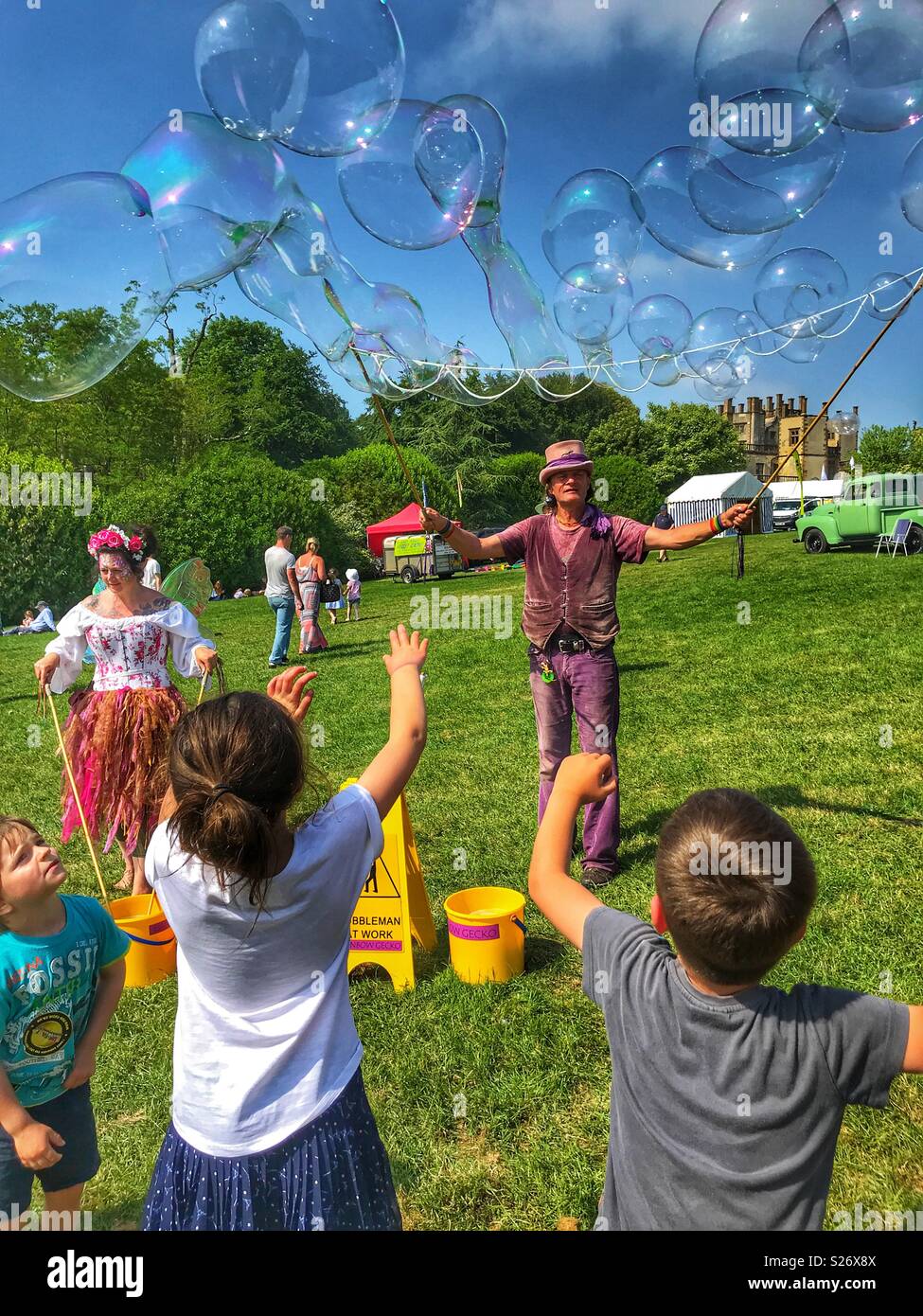 Entertaining children at Sherborne Castle Country Fair with giant soap bubbles, Sherborne, Dorset, England - Smartphone Captured Stock Image