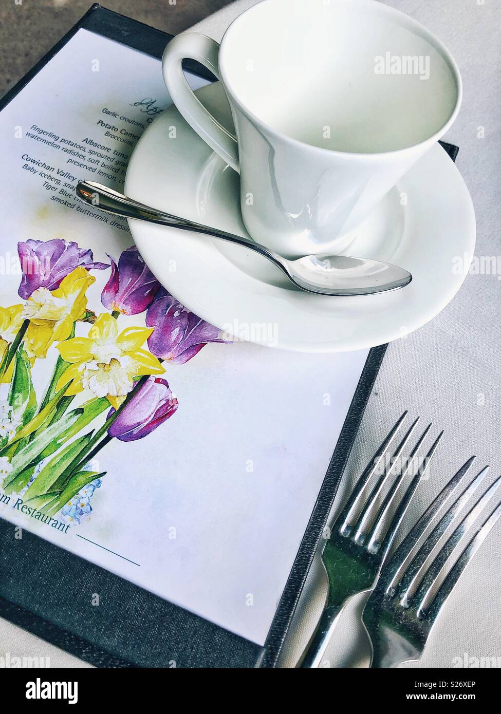 Menu and teacup on a table Stock Photo