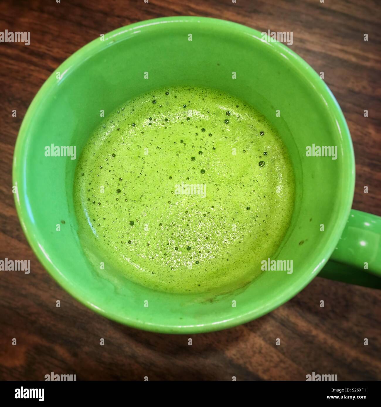 Matcha latte in green mug Stock Photo