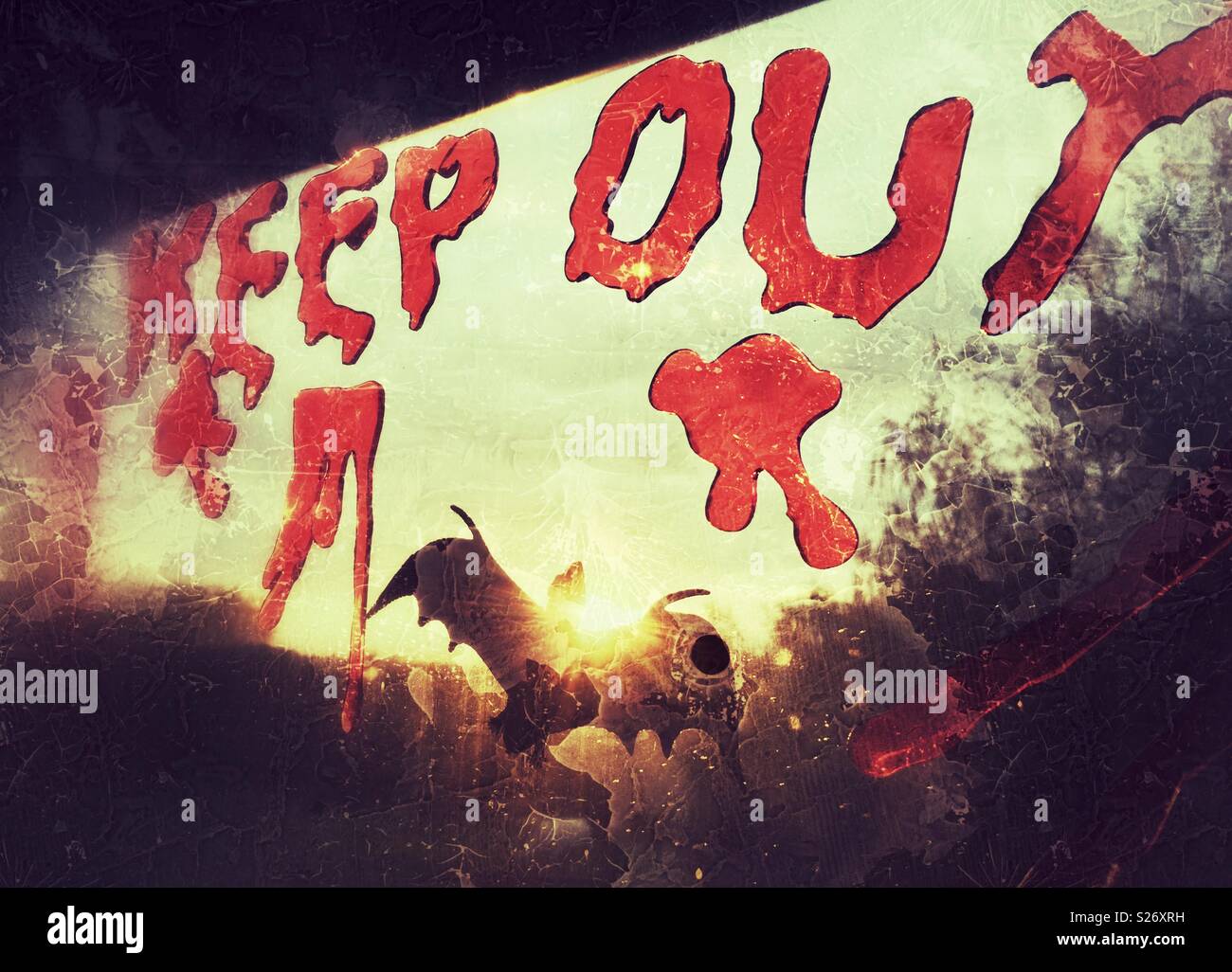 Bloody looking writing on a window reads Keep Out. A Halloween window decoration to scare kids doing trick or treat. - Smartphone Captured Stock Image