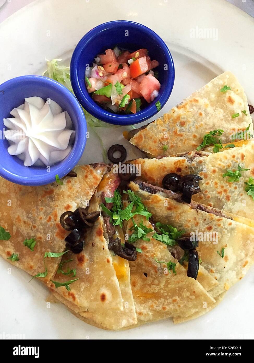 Entrée in an upscale Mexican restaurant of quesadilla and assorted toppings, New York City, USA Stock Photo