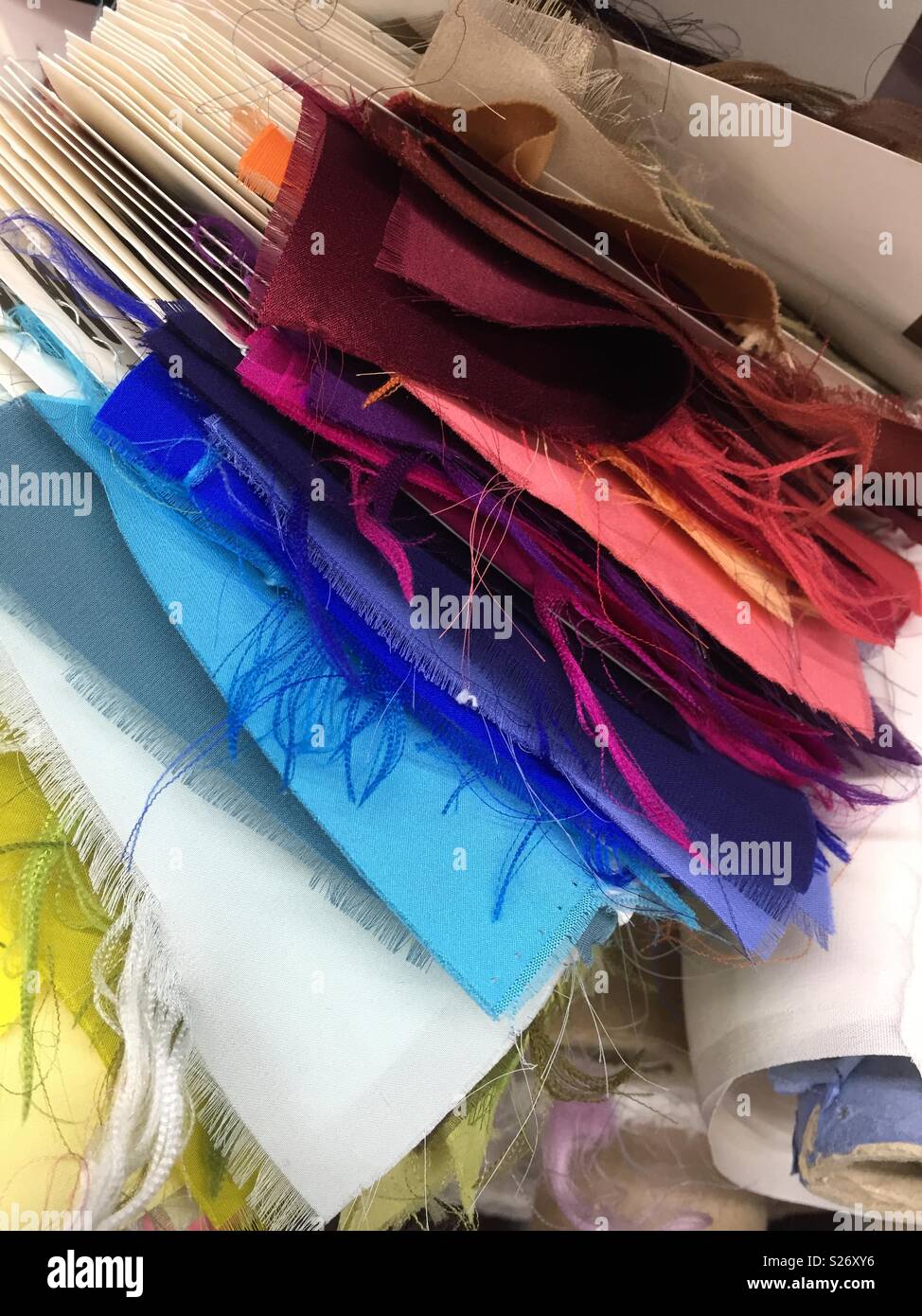 Fabric swatches on display at a designer fashion fabric store in the