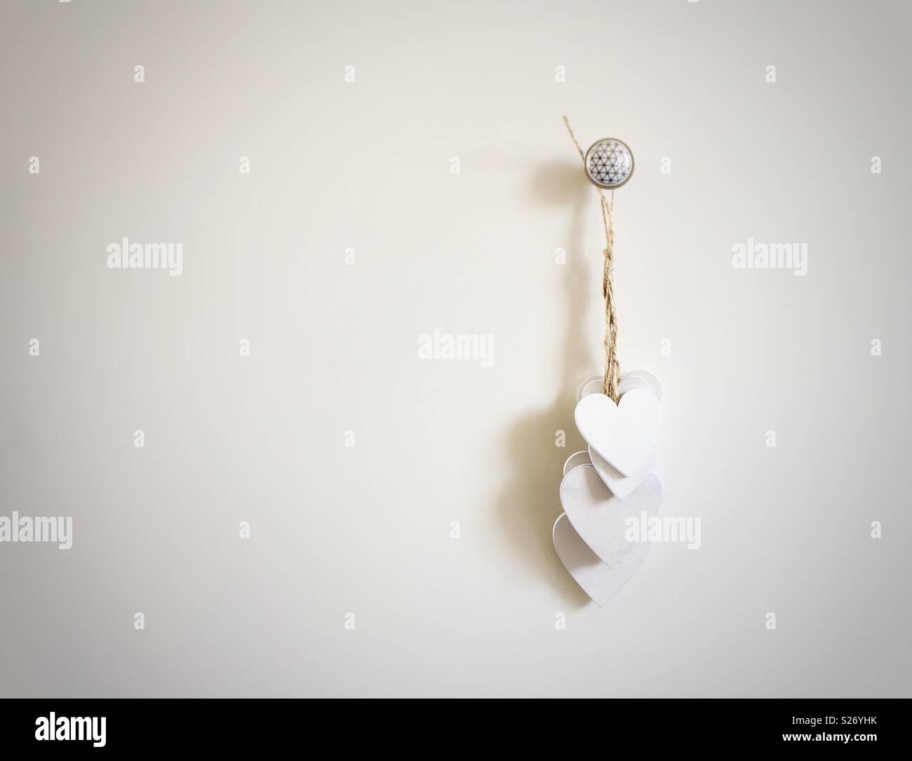 group of white wooden hearts hanging - Smartphone Captured Stock Image