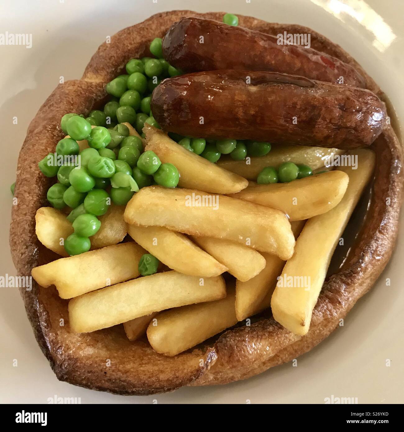 Giant Yorkshire with chips peas sausages - Smartphone Captured Stock Image