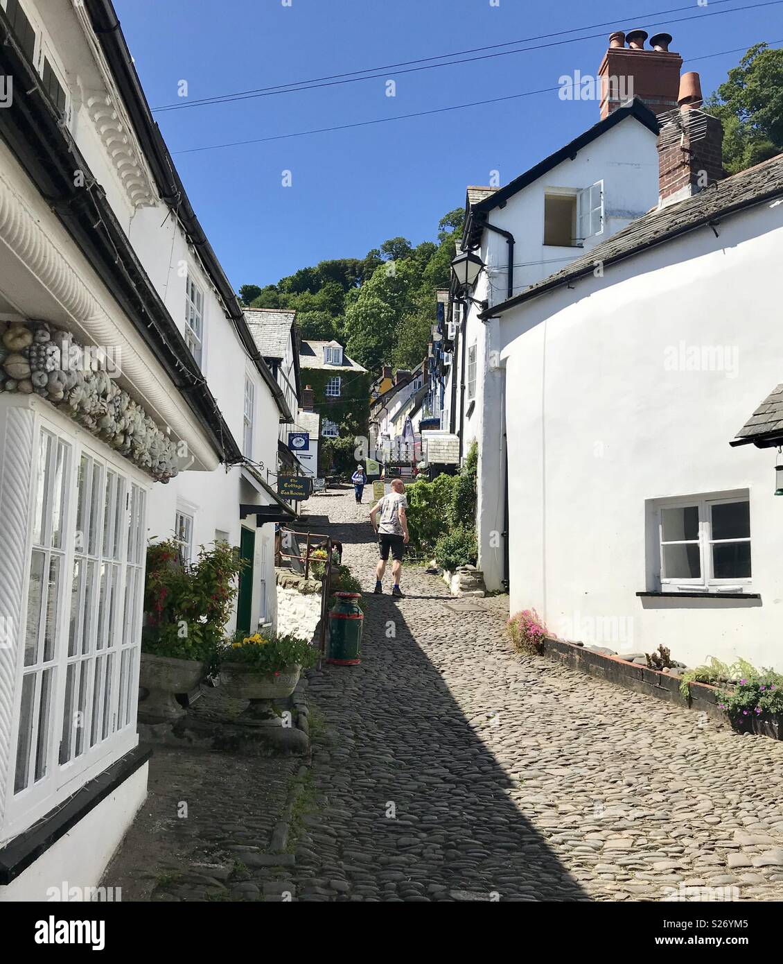 Walking up the cobbled street in Clovelly Devon Stock Photo