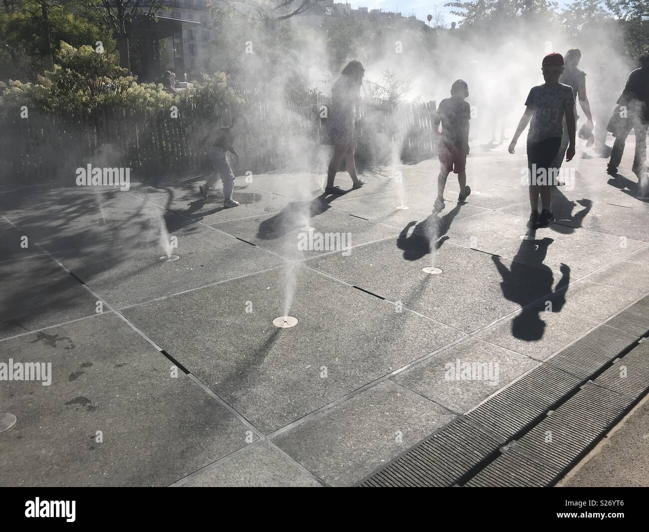 Paris. France. People walking among cooling mist on a hot summer day - Smartphone Captured Stock Image