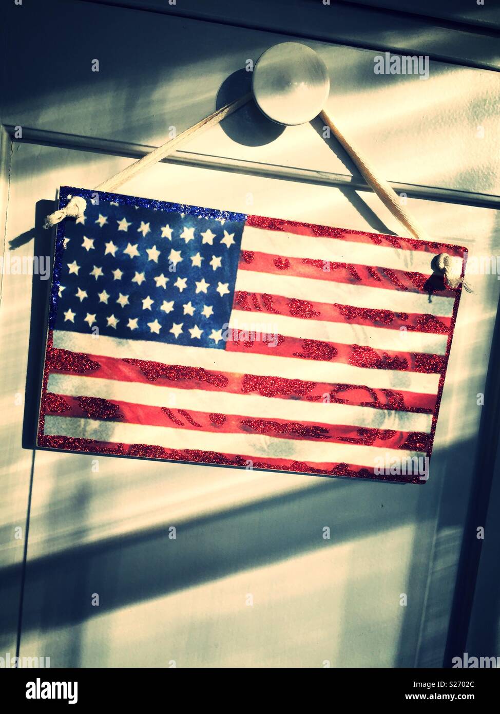 Wooden American flag sign suspended with rope, USA - Smartphone Captured Stock Image