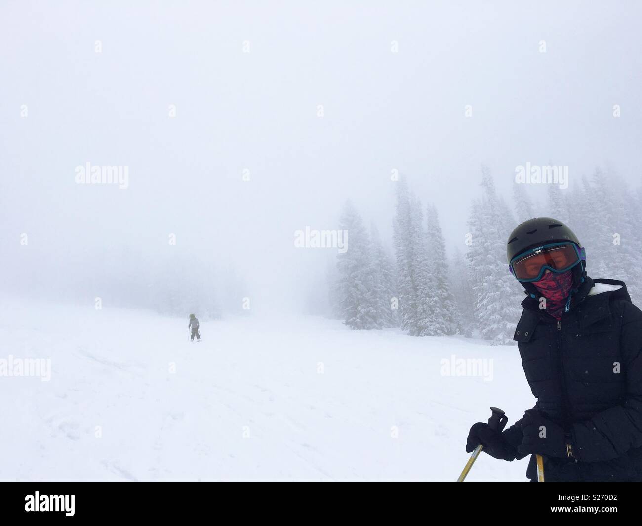 Two girls skiing in heavy snow, Steamboat Springs, Colorado. Stock Photo