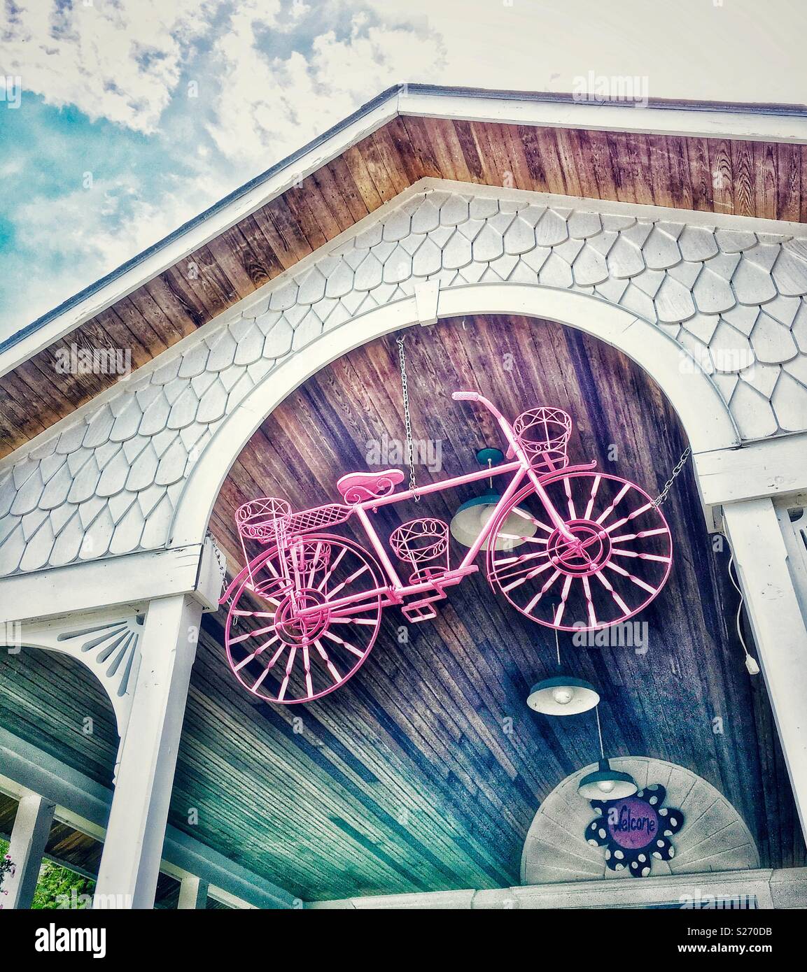 Bicycle hanging from entry of storefront - Smartphone Captured Stock Image