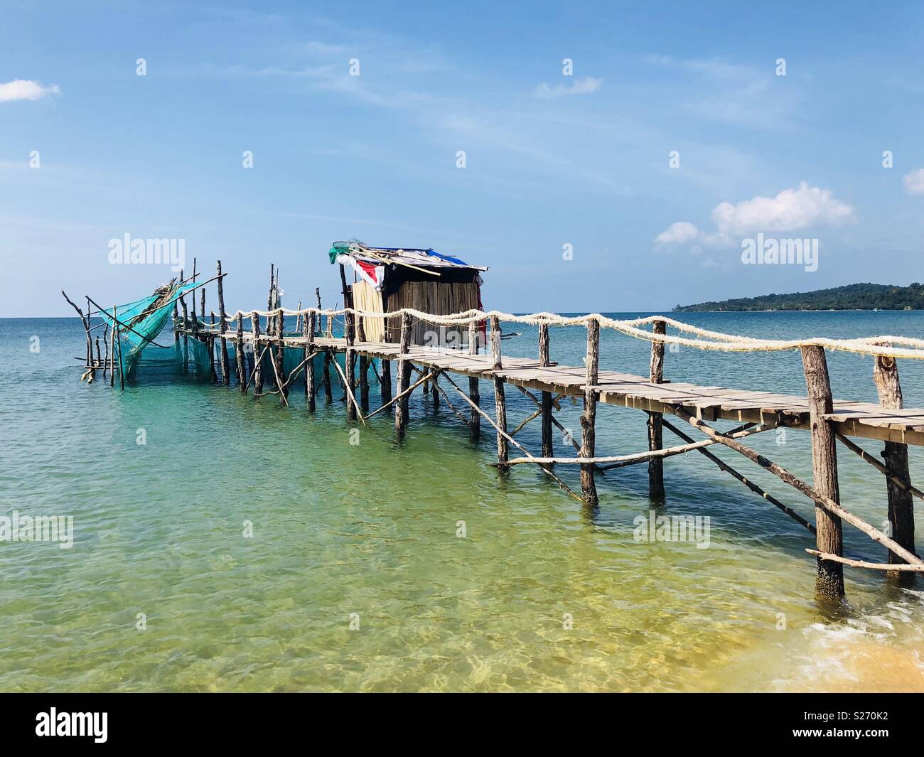 https://c8.alamy.com/comp/S270K2/fishing-pier-on-a-tropical-beach-with-fishing-nets-and-hut-S270K2.jpg