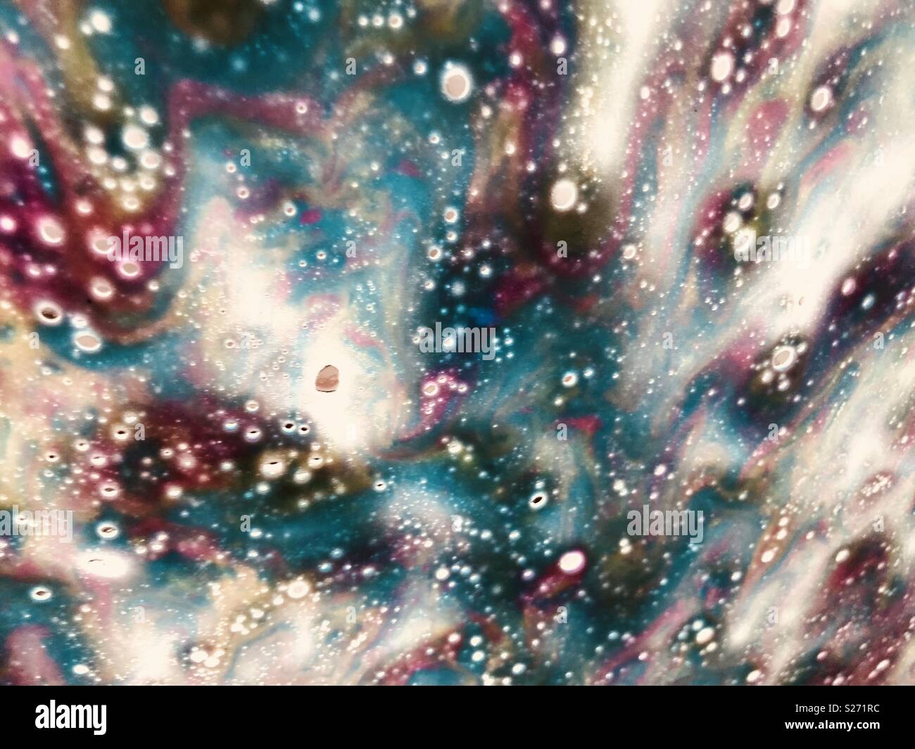 Soap suds on a car window going through a car wash make a vibrant and colorful abstract pattern. Stock Photo