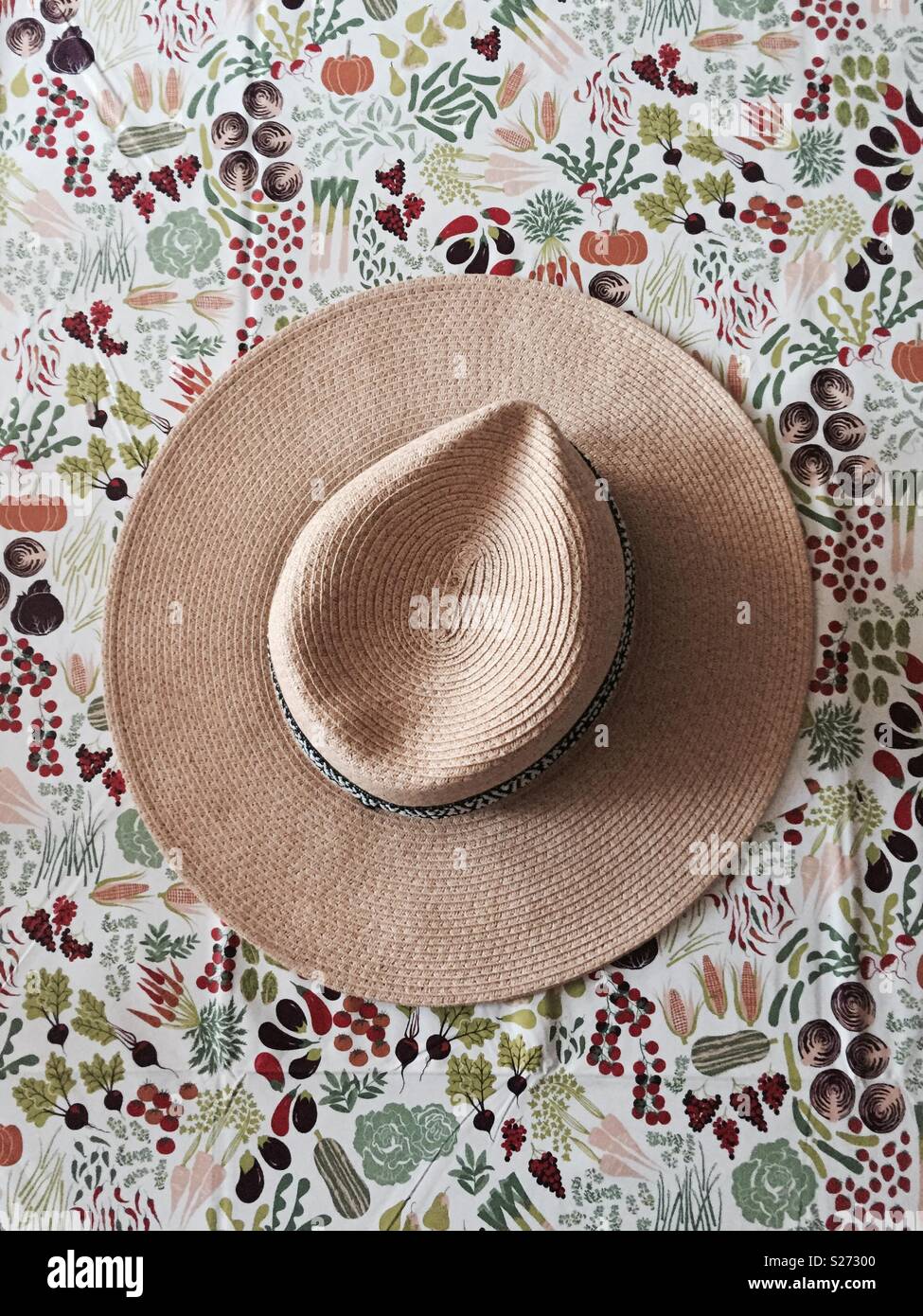 Straw hat on colourful table cloth - Smartphone Captured Stock Image