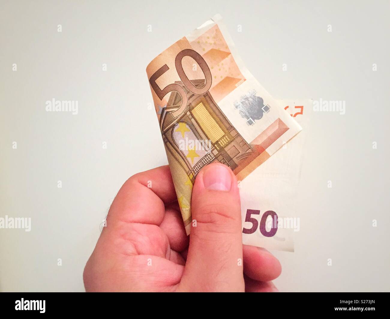 Male hand holding a 50 euro banknote - Smartphone Captured Stock Image