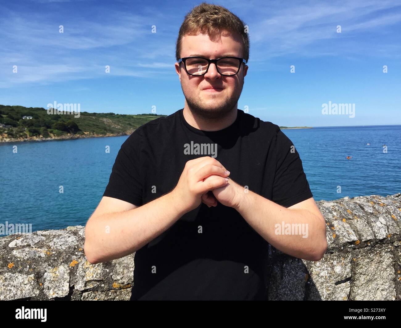 A man cracking his knuckles together - Smartphone Captured Stock Image