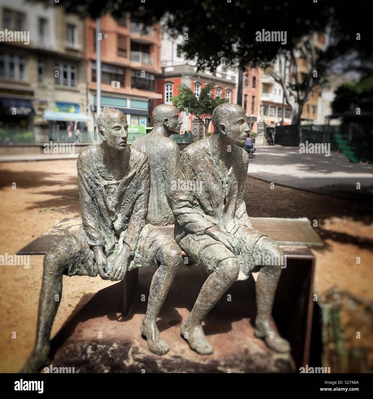 Statue of Three Men sitting on a bench waiting in Santa Cruz, Tenerife, Canary Islands. Stock Photo