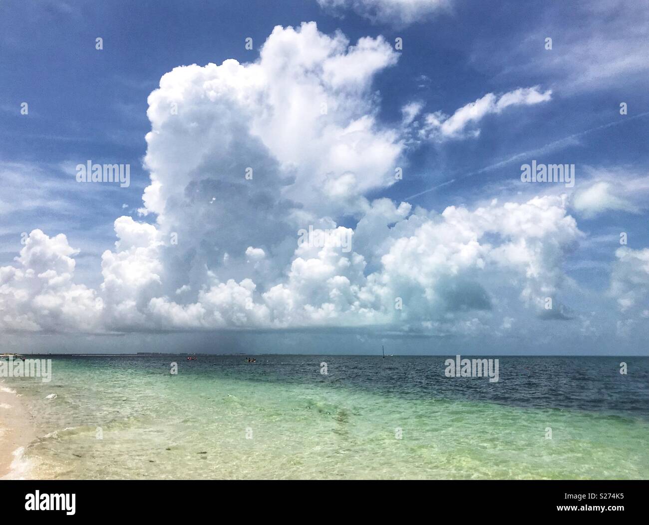 Cumulus cloud growing into a cumulonibus storm cloud over the Caribbean sea, in Playa Mujeres, near Cancun, Mexico. - Smartphone Captured Stock Image