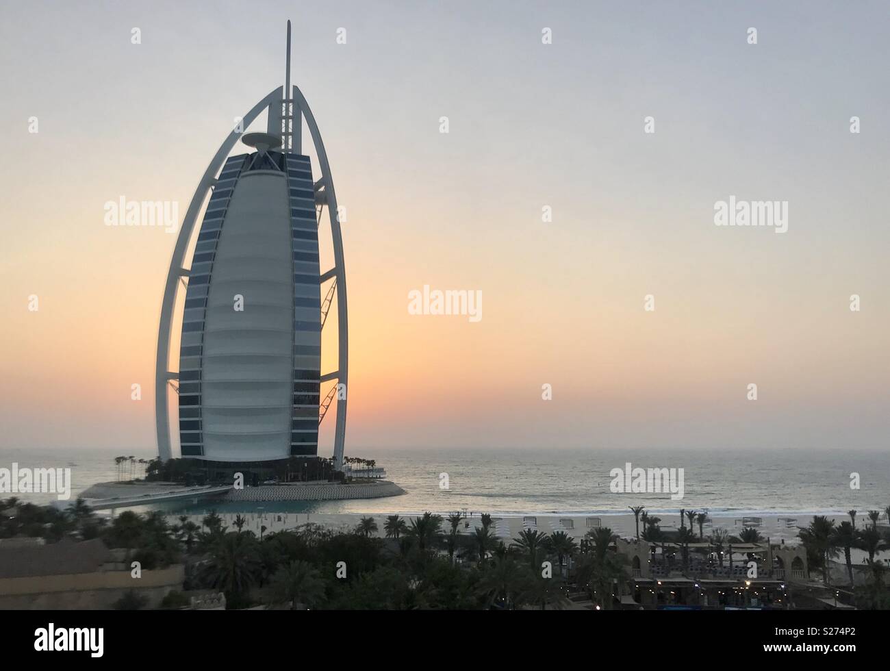 The Burj al Arab with the sun setting behind it. Stock Photo
