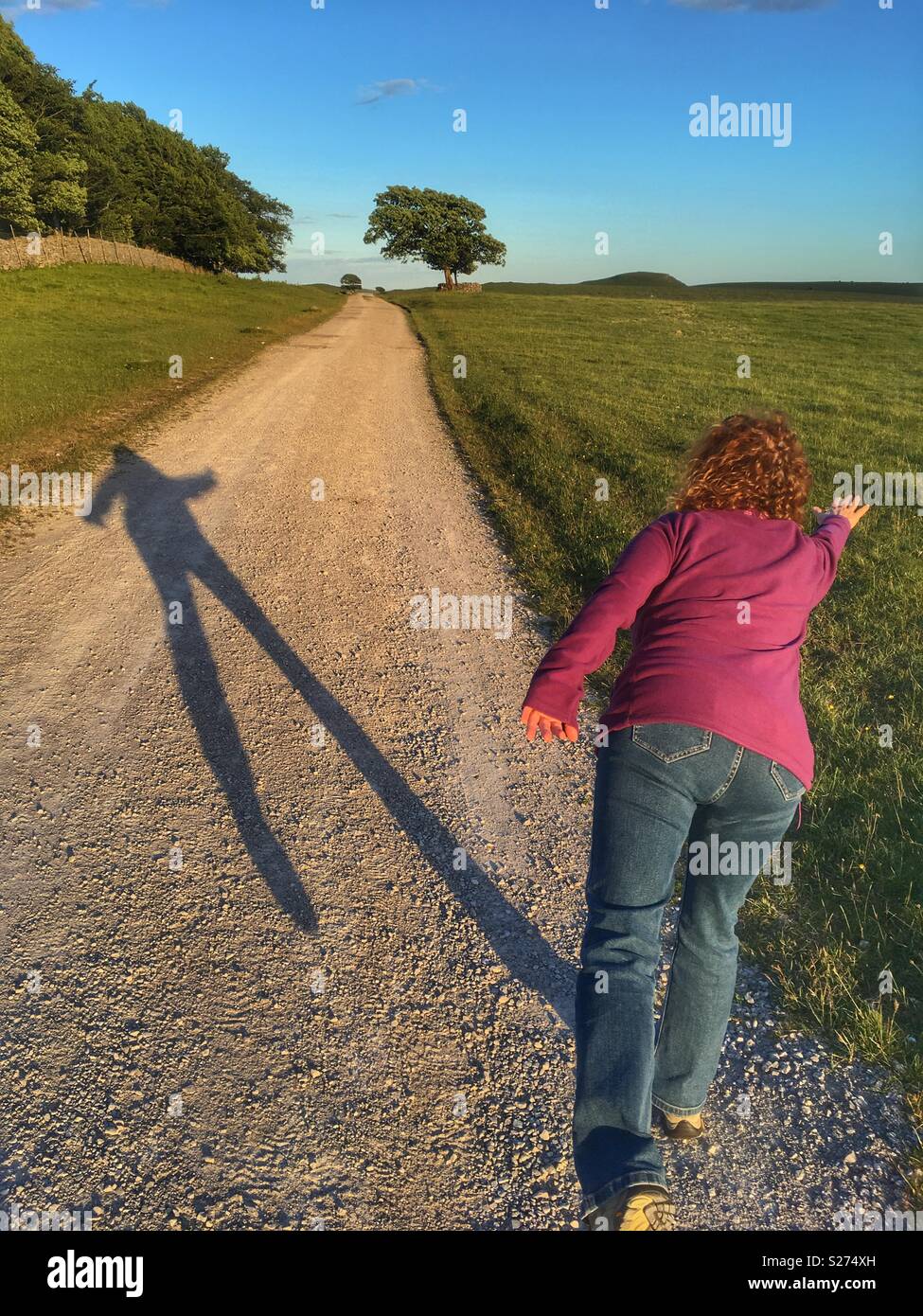 Woman making a shadow on a footpath in the Yorkshire Dales - Smartphone Captured Stock Image