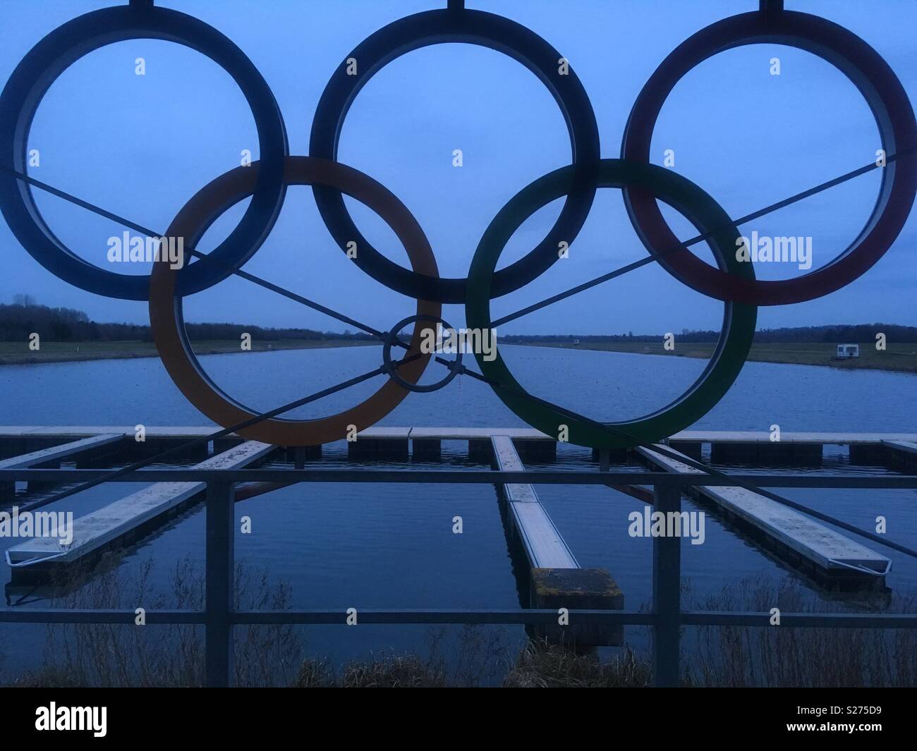 View through the five Olympic Rings out along Eton Dorney lake, a London 2012 Olympic venue, on a Spring evening. Stock Photo