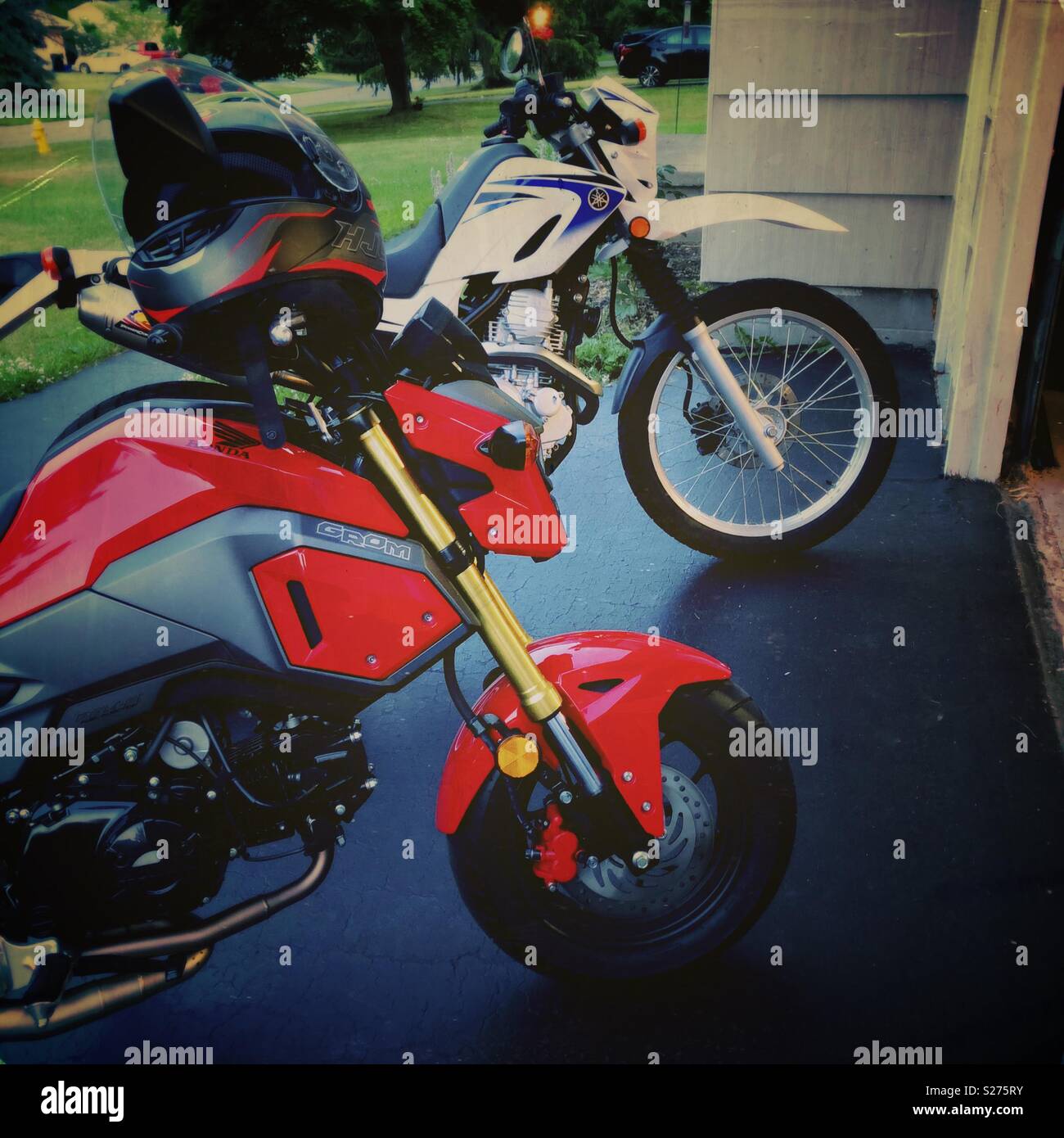 Two Honda motorcycles in driveway - Smartphone Captured Stock Image