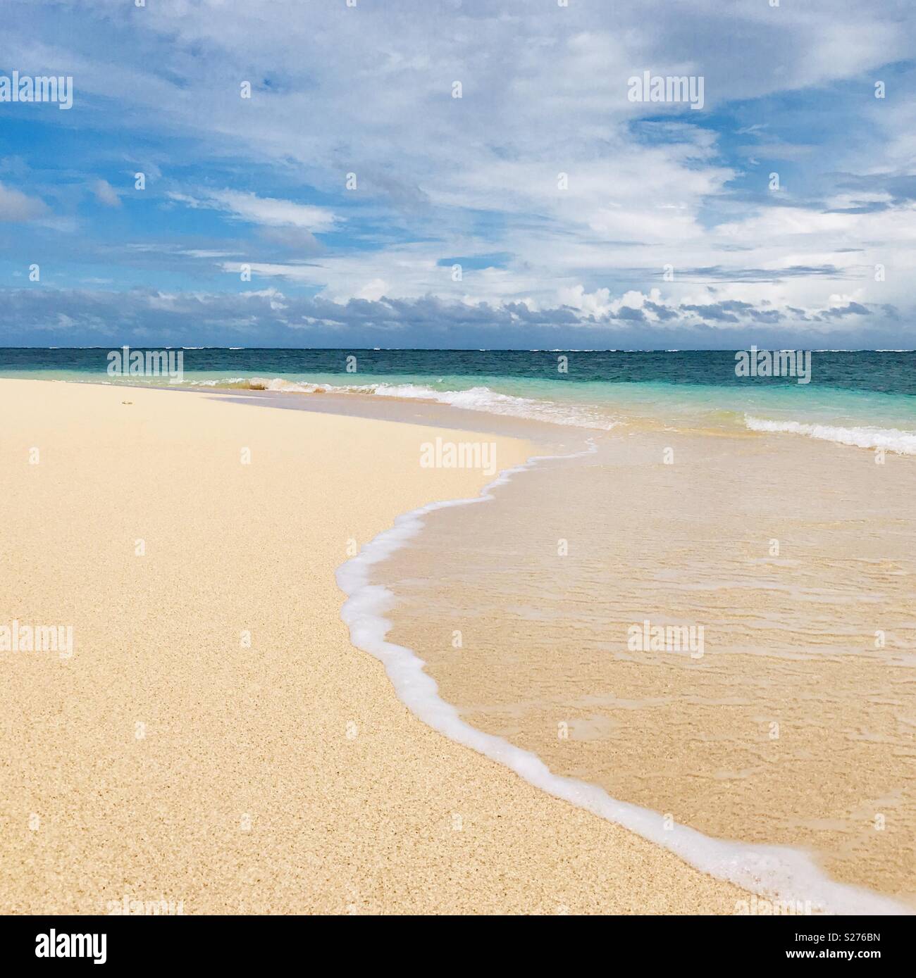 Waves rolling on shore on an empty beach. Tavarua island, Fiji. - Smartphone Captured Stock Image