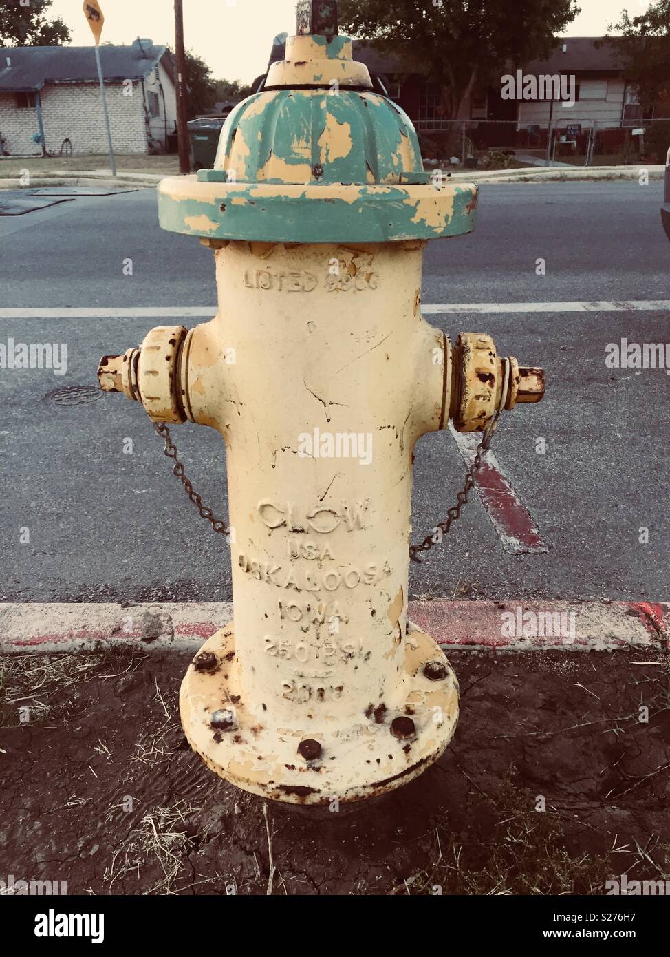 Yellow and green fire hydrant. Stock Photo